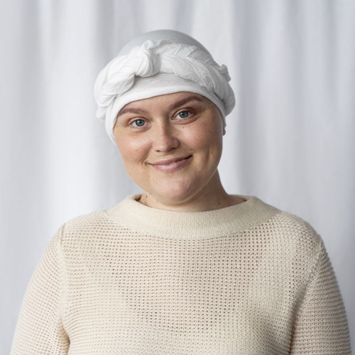 A female patient is wearing a cooling towel.