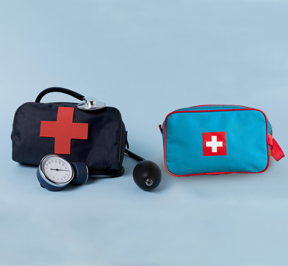 The red and black color first aid kits are kept alongside medical supplies.