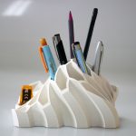 A different pens are places in desk item. The grate way to promote your business with event giveaways like this white color desk item.