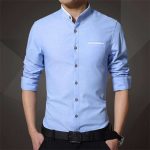 The boy is wearing a branded light blue shirt.