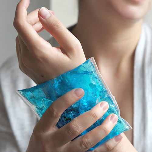 A woman is using a Faddico customized ice pack to get relief from pain.