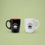 A drinkware promotional mugs for companies in white and black color with company logo.