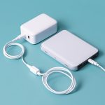 A white color portable phone charger with company logo made by Faddico for events giveaways.
