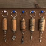 A range of recycled keychains are hanged on wall board.
