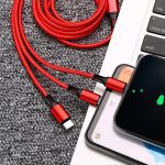 Two cell phones are being charged together with a two-in-one data cable.