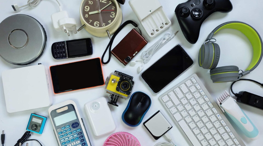 A different promotional gadgets items including Headset, keyboard, mouse, charger, cell phone are places together.