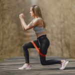 A girl exercising using a fitness band.