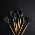 Various spoons used for cooking in the kitchen are neatly arranged.