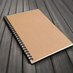A notepad is placed on the table and can be customized for company promotion.