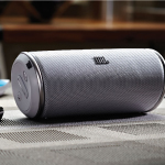 A gray color portable speaker is customized with company logo for branding.