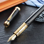 A black pen with its cap off, placed on the table.