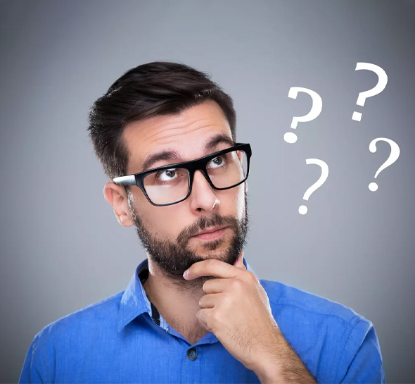 A person wearing a blue shirt and glasses is deep in thought