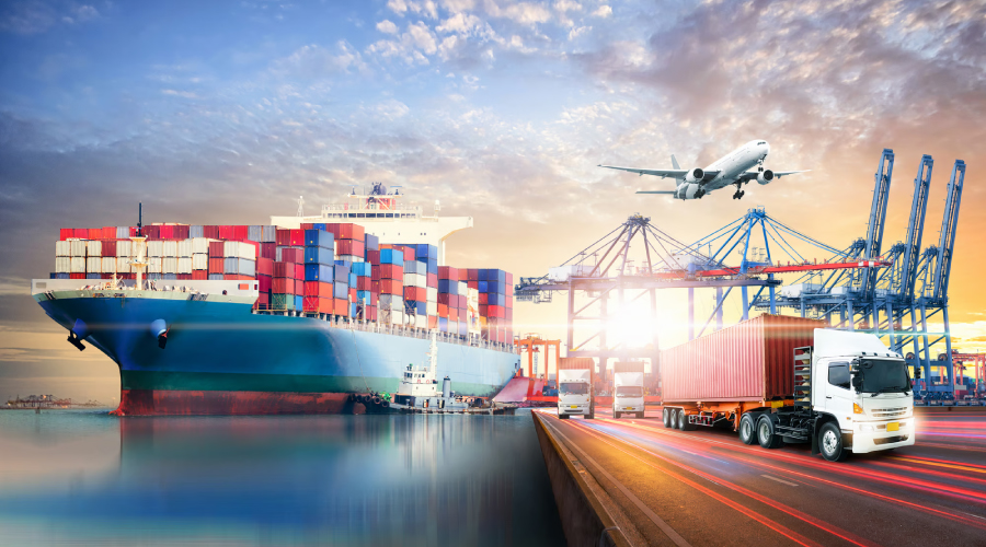 Containers of imported and exported promotional products are transferred from a large ship to a smaller vessel and then loaded onto trucks for distribution.